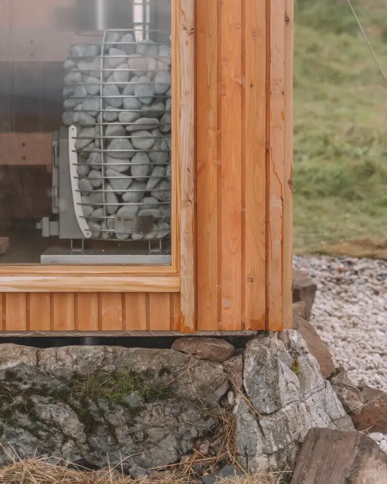 Detail of Ardna’s timber cladding, window and stone base